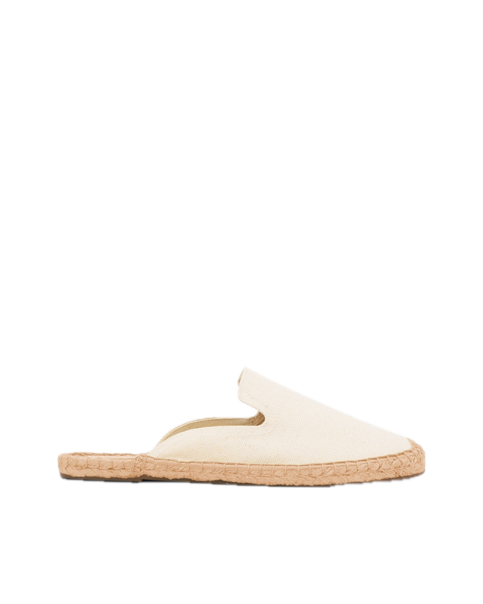 A pair of undyed cream cotton canvas backless mules on braided jute soles.